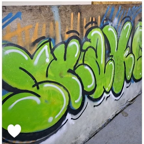 Green bubble-letter street graffiti piece